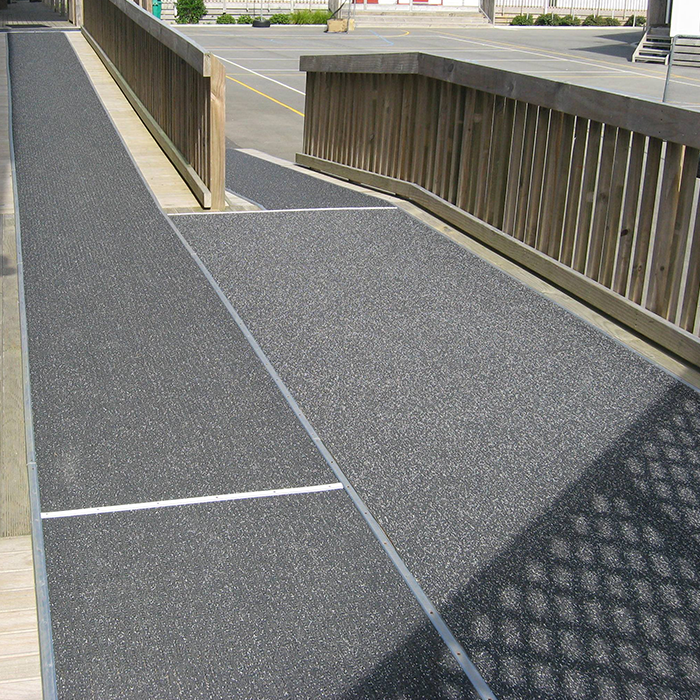 Black rubber mat on wooden walkway