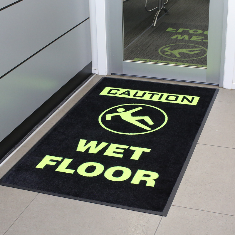 Fluro rubber mat with Caution Wet Floor signage outside door