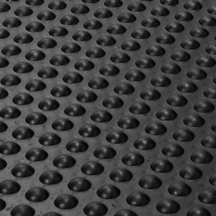 Swatch of black anti fatigue mat with raised circle tredding